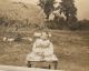 Photo of Very Young Child Sitting On Chair In A Field Photo of Very Young Child Sitting On Chair In A Field